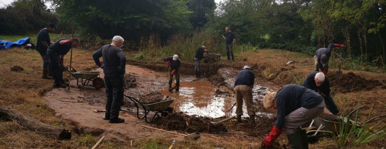 A group of volunteers prepare the Chaddesden Park pond liner.
