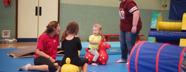 Springtots children and adults on mats