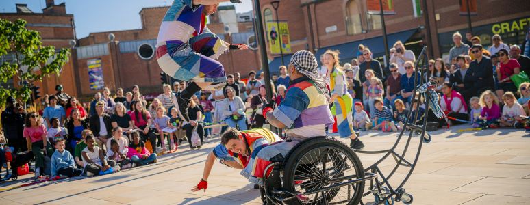 Performers at Derby Festé display acrobatics outside in the sun
