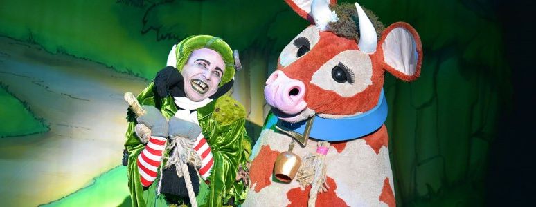 Cess Pitt smiles whilst Pat the Cow looks on