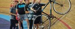 Children on cycling track with coach