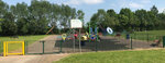 photograph in grass in foreground and playground with rides and slide in background photograph in grass in foreground and playground with rides and slide in background