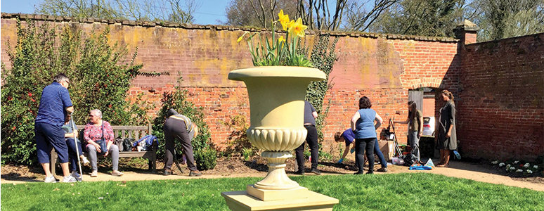 People gardening in the Markeaton rose garden