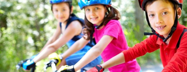 Three Children cycling together 