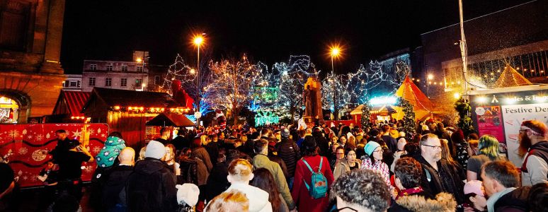 A crowd gather in a festive setting.
