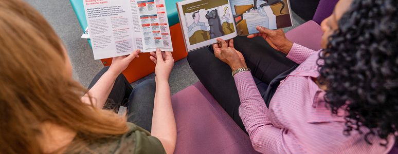 two women looking at reading well books for mental health