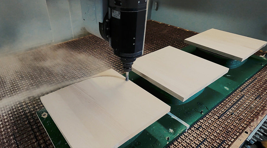 ercol 1877 Windsor chair seat being cut out in the CNC machine