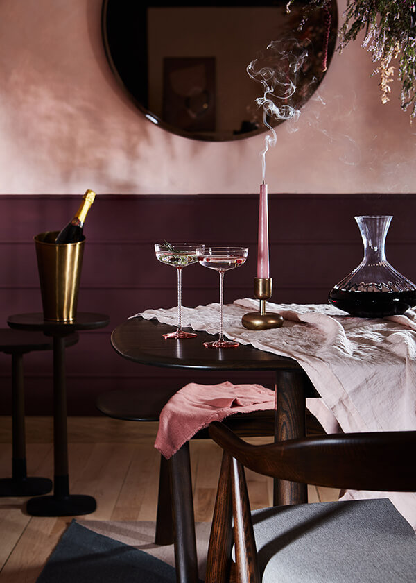 Photography: Lol Johnson Photography @still_loljohnsonphotography A recently extinguished candle smoking, sat on a Corso table alongside champagne glasses