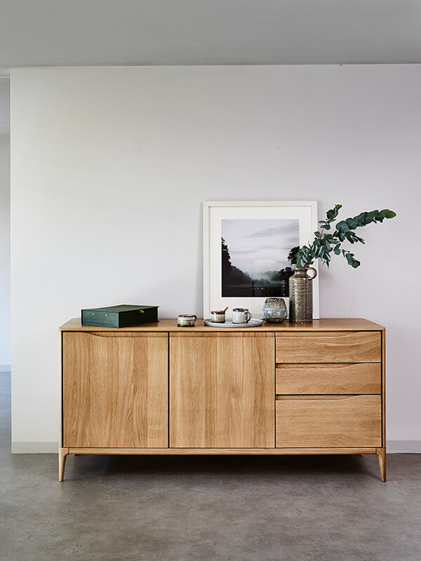 Romana large sideboard Romana large sideboard, with various items on top including a picture frame, green leafy plant, green box and tea set