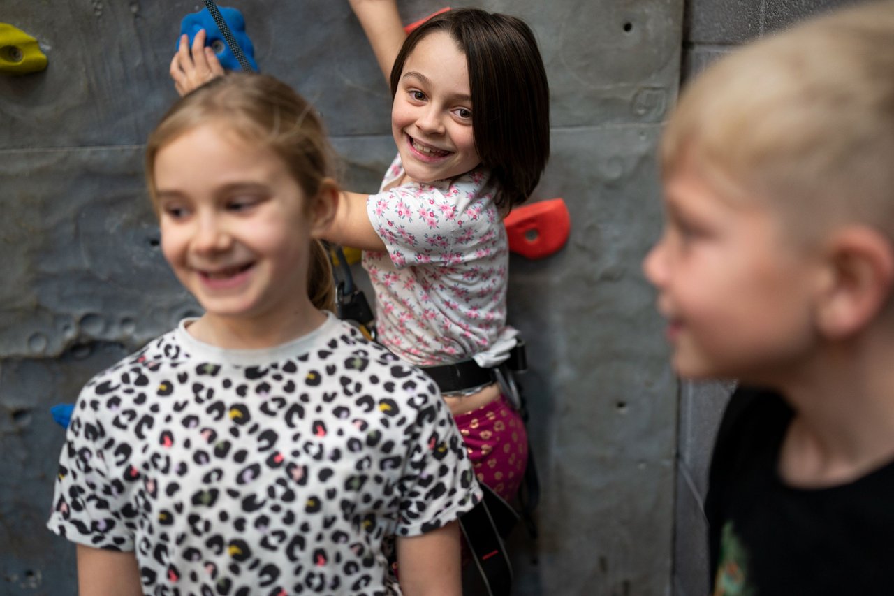 girl climbing and smiling at camera