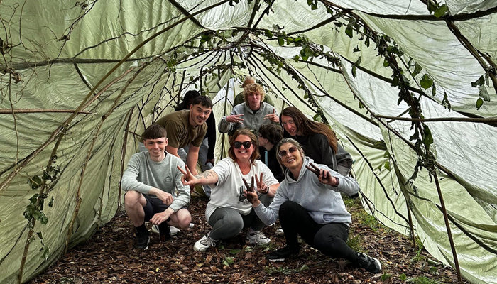 group posing under shelter