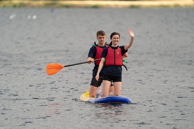 pair paddling and smiling