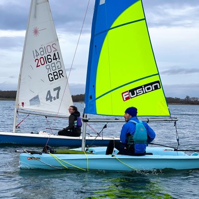 two boats sailing next to each other