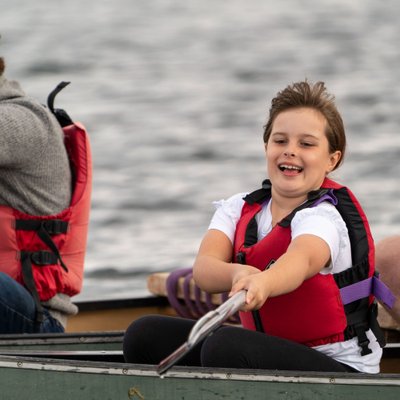 girl reaching with her paddle in canoeing