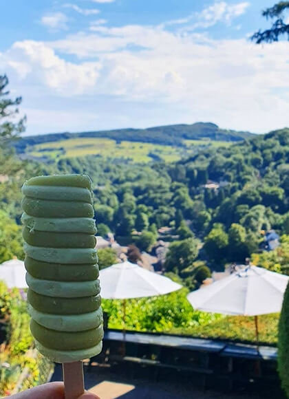 Close up of an ice lolly in front of scenic views over Matlock