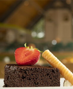Chocolate brownie dessert with half a strawberry on top