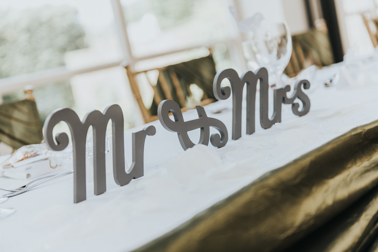 Image credit: Averill Photography Close up of Mr and Mrs decor on wedding head table