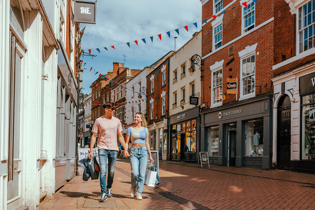 Couple holding hands shopping on Sadler Gate Derby