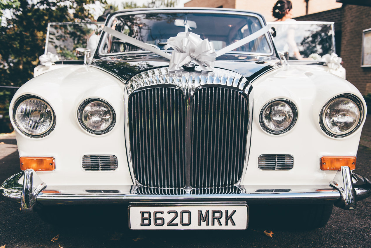 Close up of the front of a vintage wedding vehicle