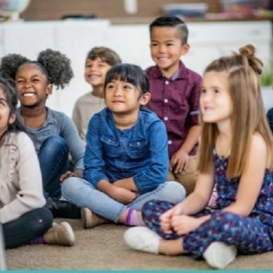 Children sitting on a floor enjoying a story bing read to them