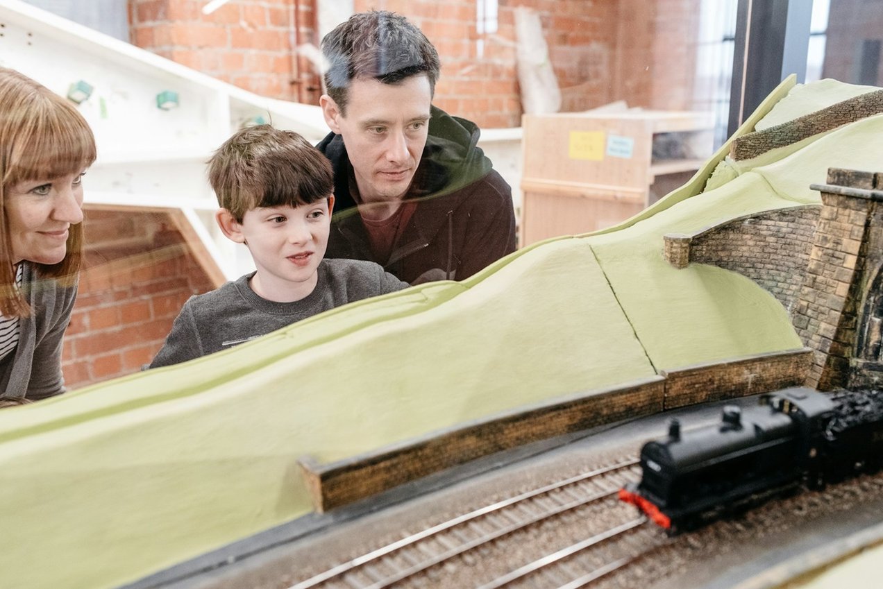 Image Credit: Derby Museums Family observing Museum of making Midland Railway Collection