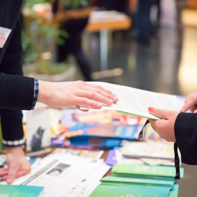 Hands holding a brochure