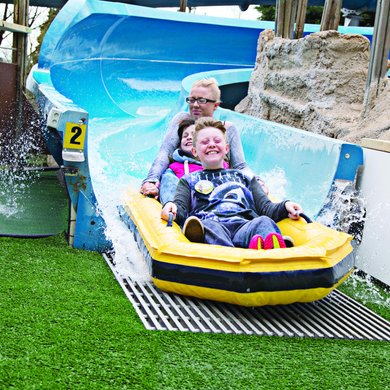 Family having fun on water slide at Gulliver's Kingdom