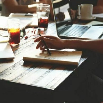 People writing at desks