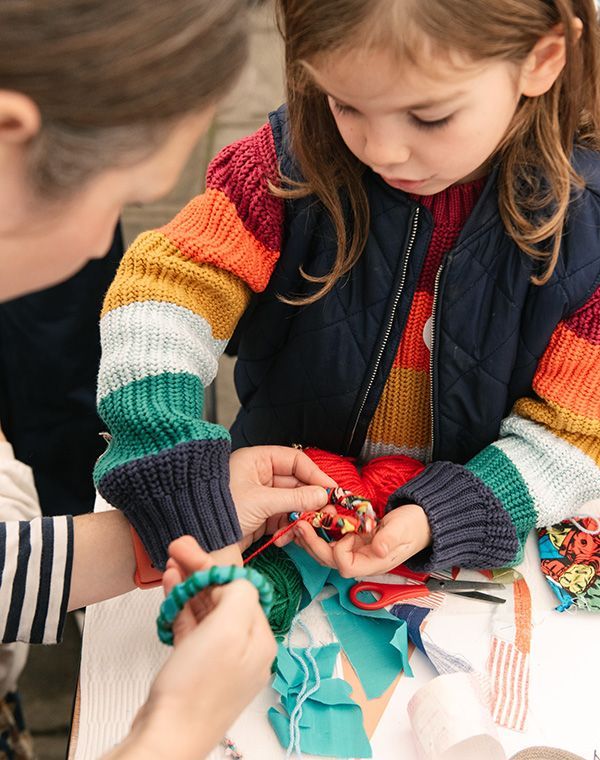Young girl crafting with a woman
