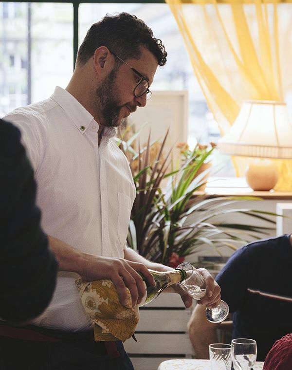A man pouring a glass of champagne