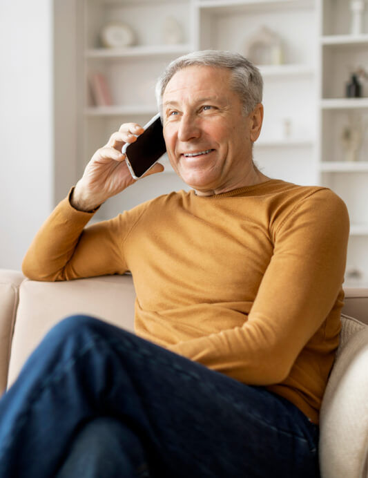 Happy senior on the phone with a SeniorConnect advisor, receiving helpful customer support