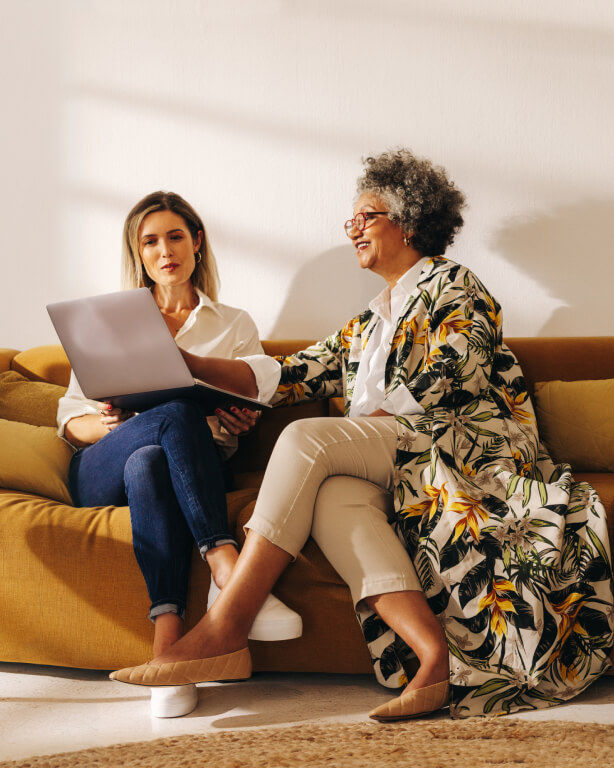 SeniorConnect advisor guiding a senior at home in a friendly, in-person style consultation