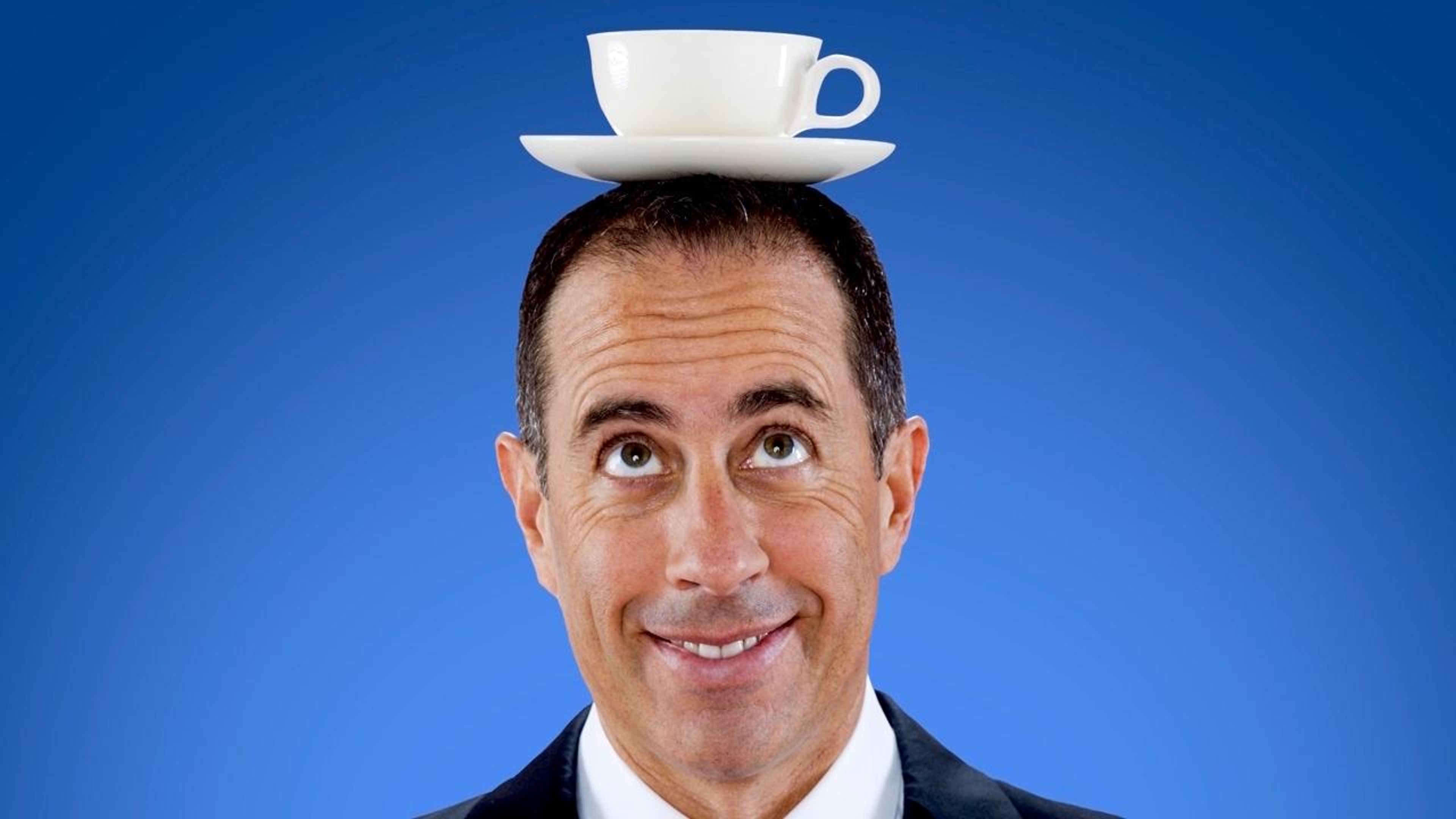 Backdrop of Comedians in Cars Getting Coffee