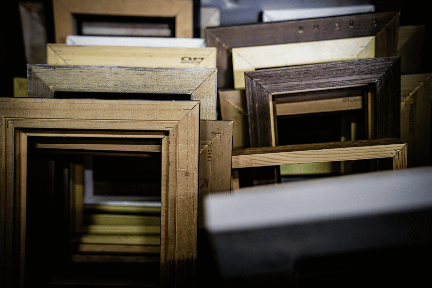 Stacked wooden frames in workshop storage area