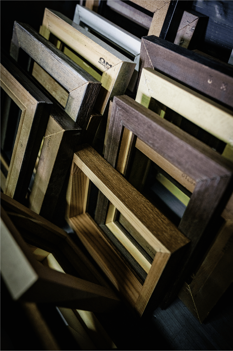 Layered wooden frames in workshop varied tones and textures