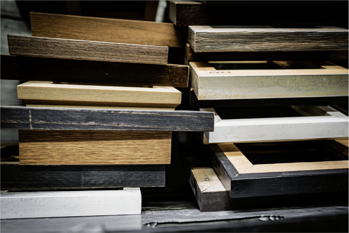 Layered wooden frames stacked horizontally with contrasting finishes