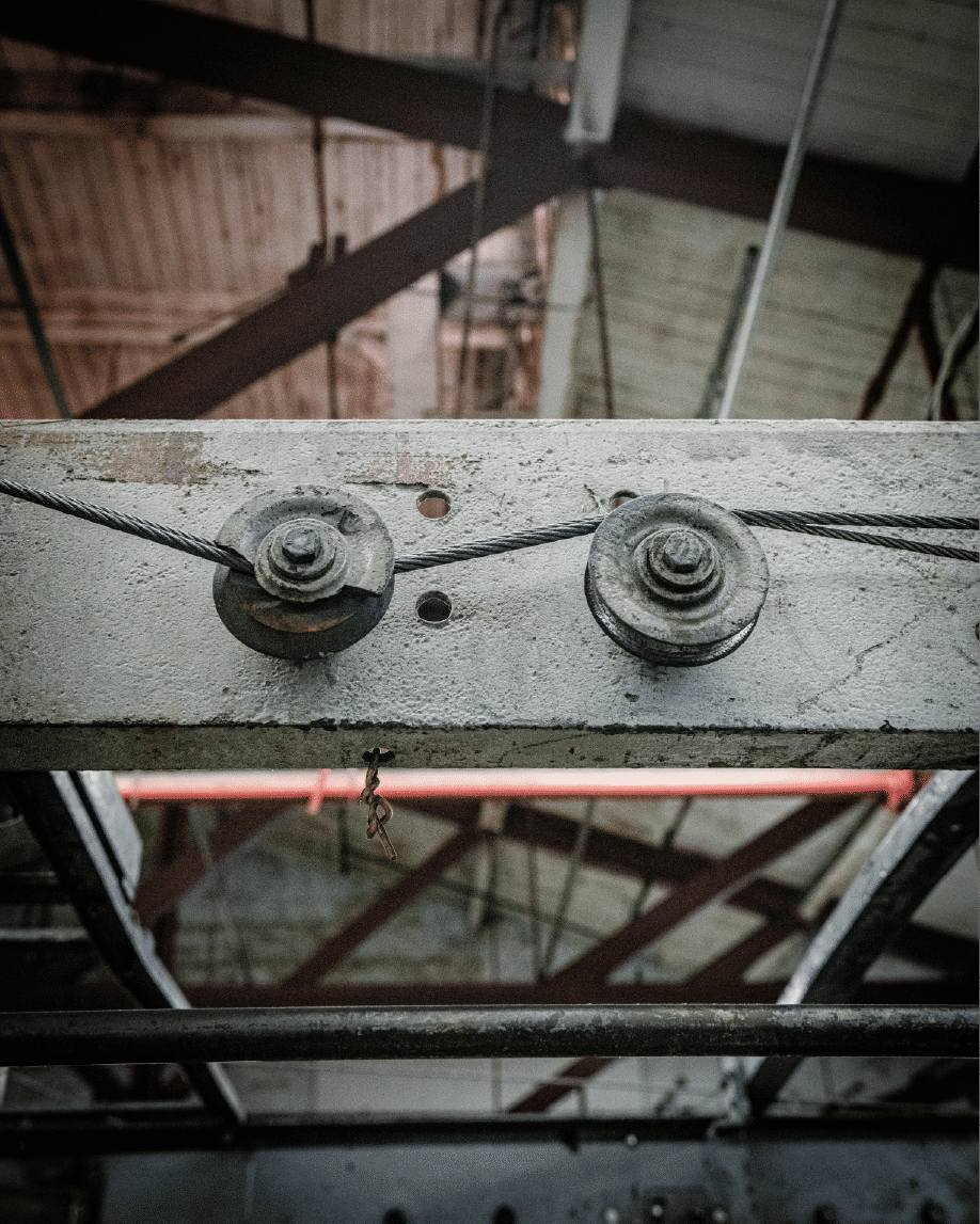 Overhead pulley system with steel cables in warehouse