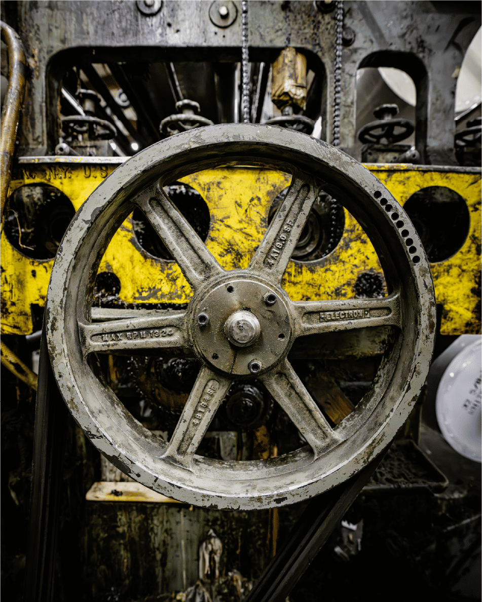 Vintage industrial wheel with worn metal and grease