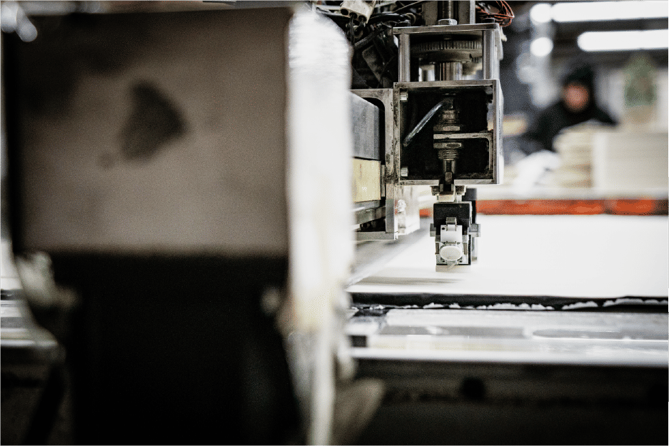 Industrial cutting machine head on flat material surface