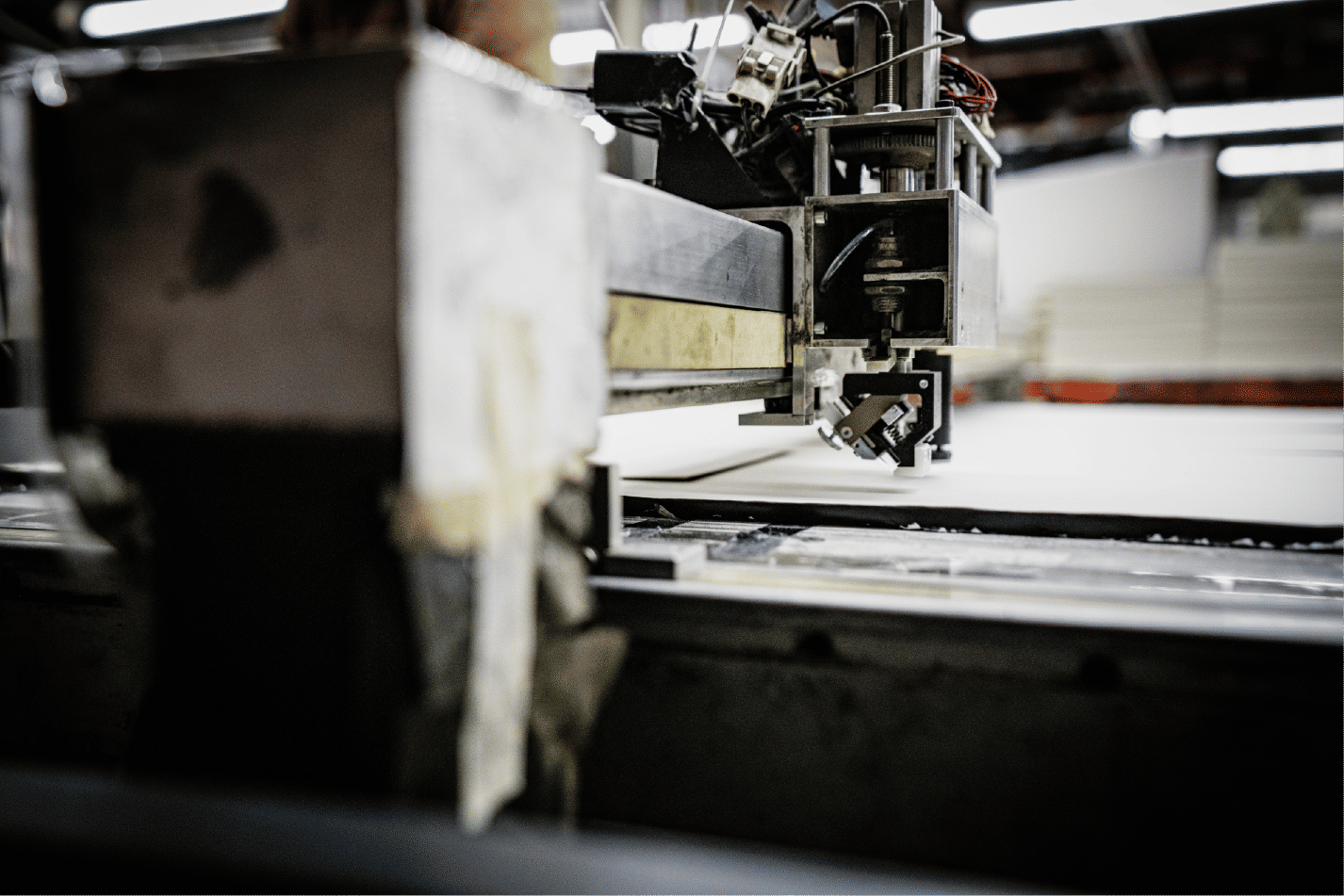 Automated cutter tool shaping sheet material in workshop