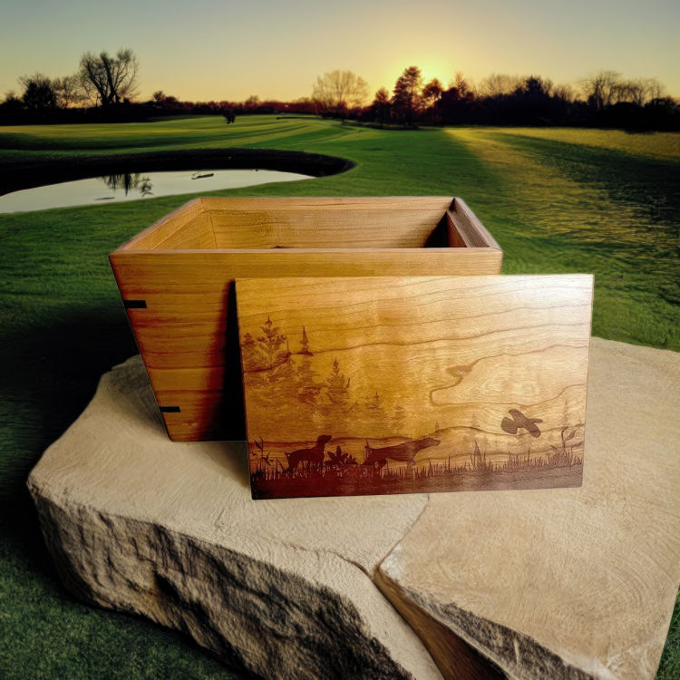 Engraved cherry wood cremation urn with forest scene featuring two bird dogs and a bird. Ideal for medium-sized urns.