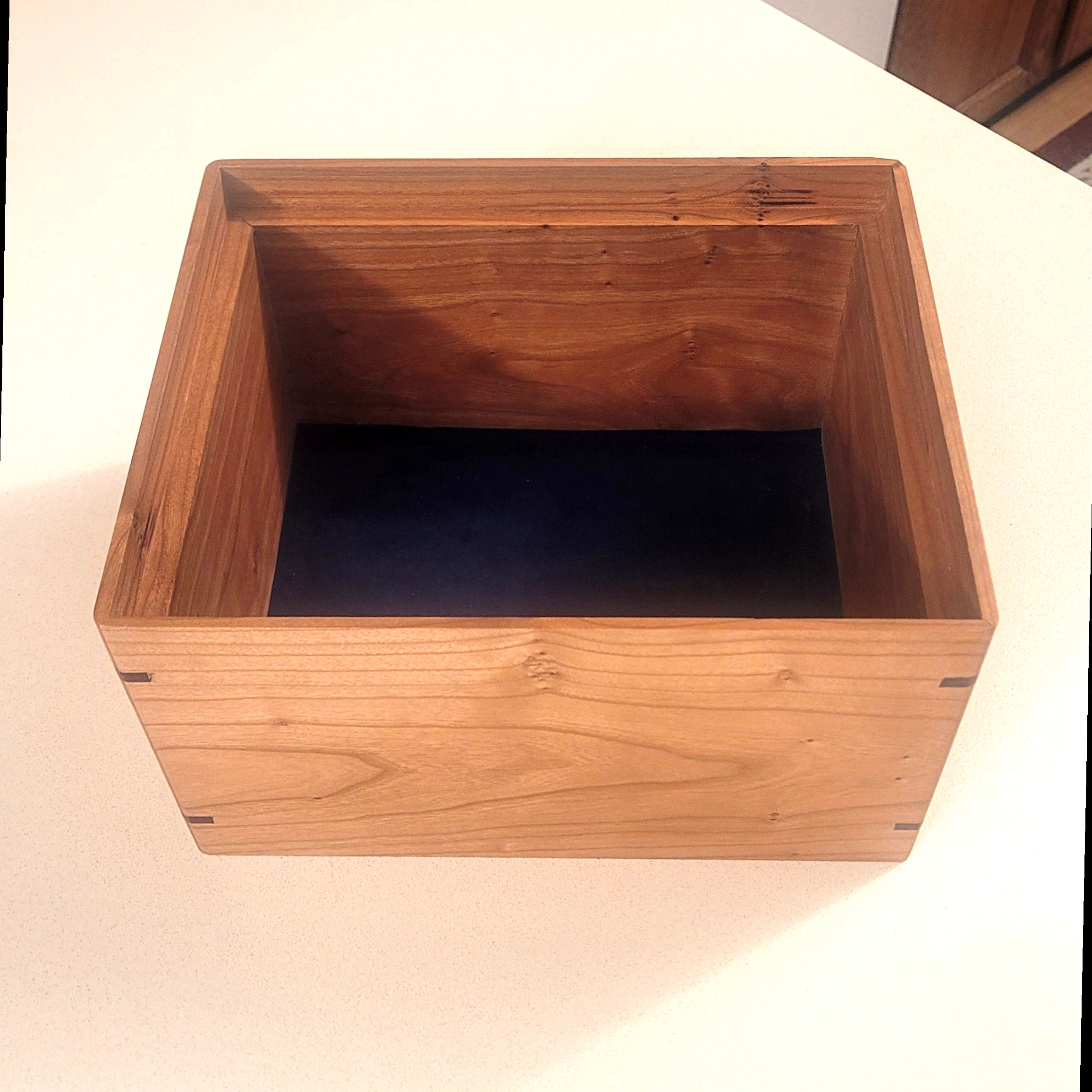 A finished handcrafted hardwood urn
