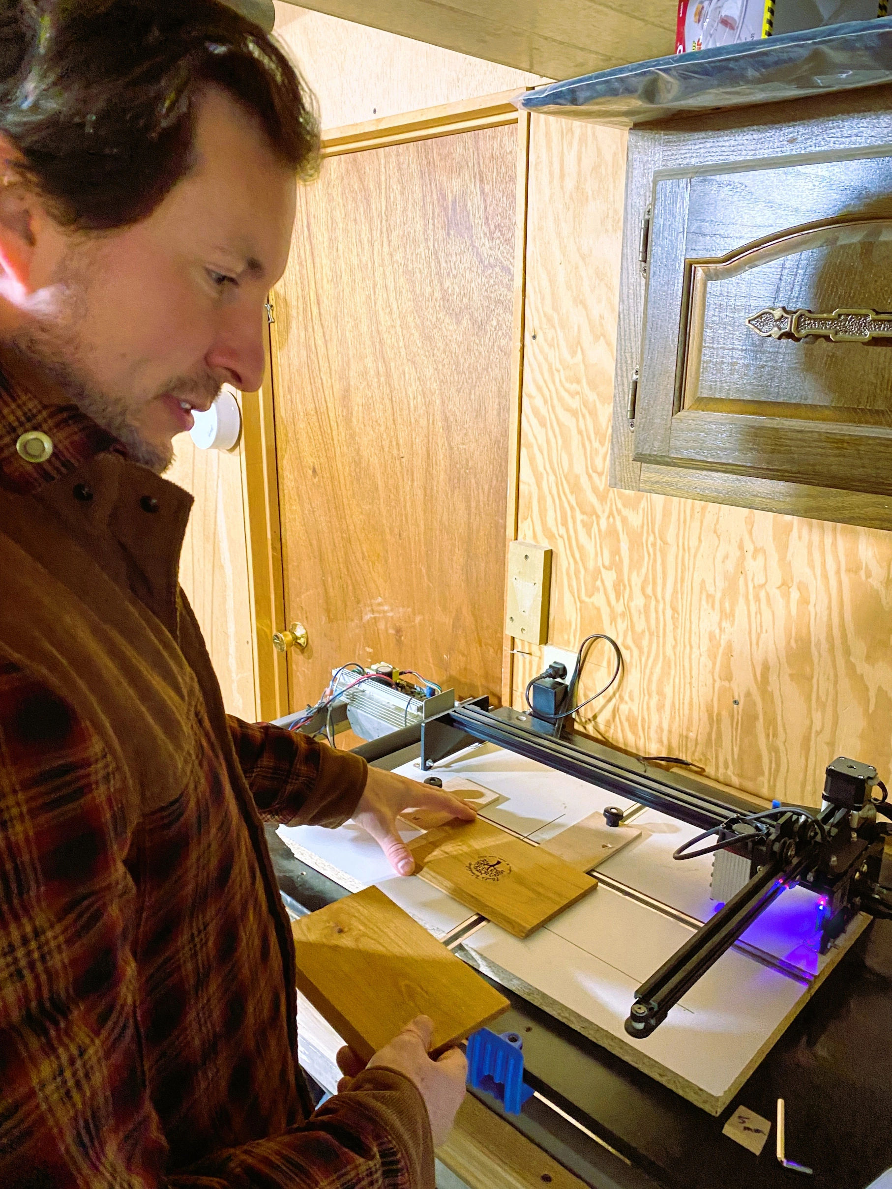 Daniel Flint laser engraving a custom wooden urn at Laser Engraved Urns