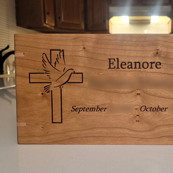 A golden tree in a peaceful meadow, symbolizing life, love, and loss; representing hardwood urns by Flint's Woodshop.