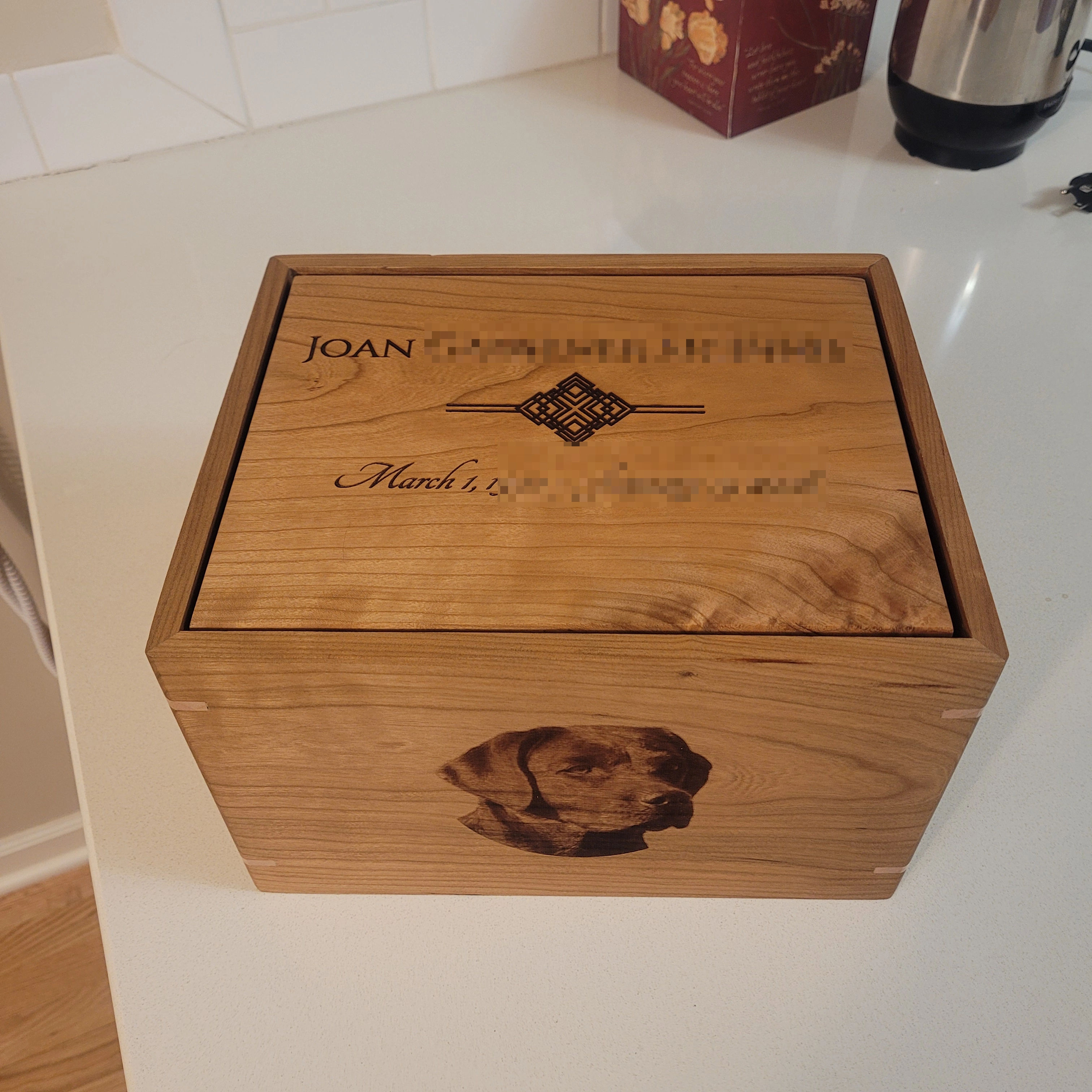 handcrafted solid cherry cremation urn with maple splines and custom laser engraved dog portrait