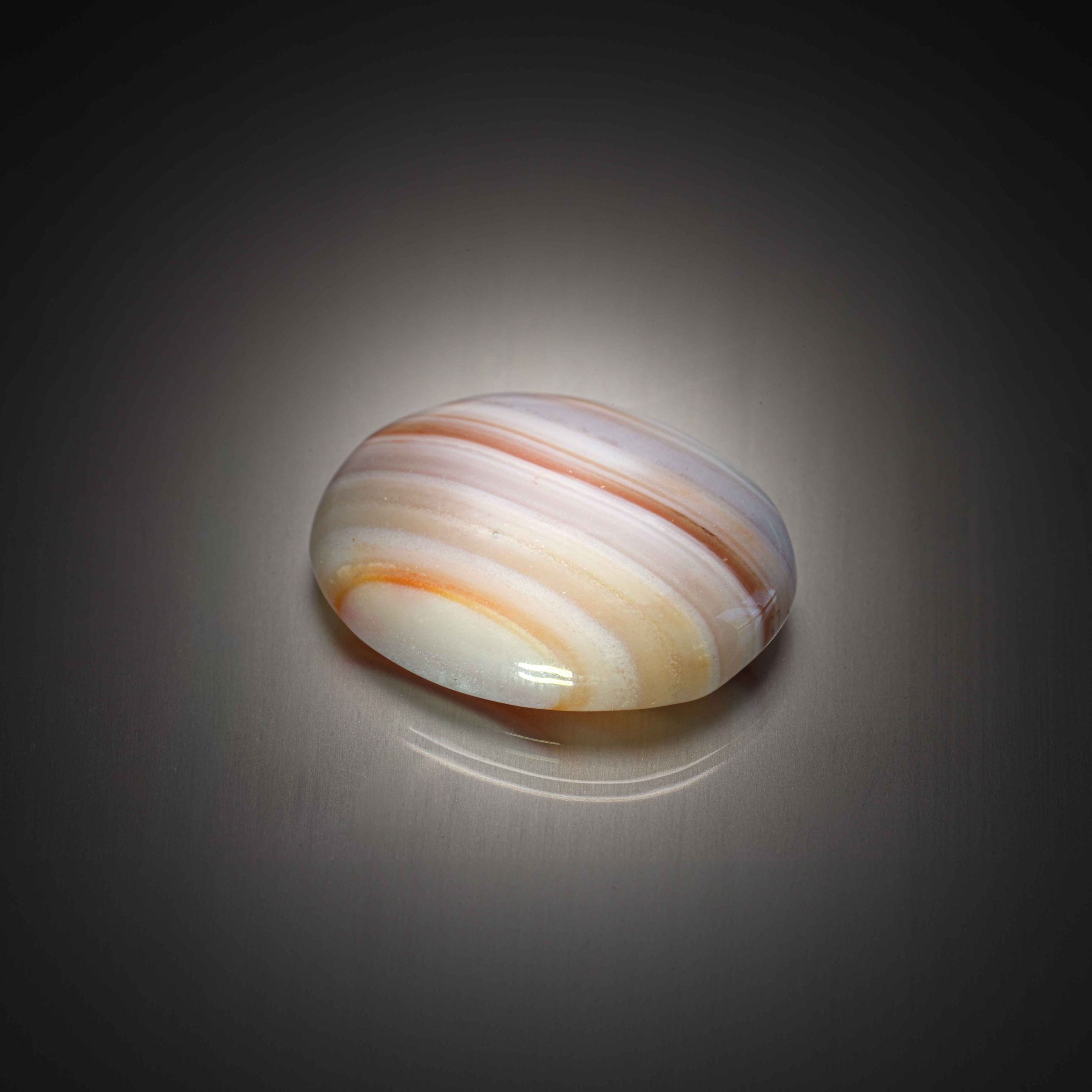 Agate multicolore ovale cabochon sur papier. - Lazuli