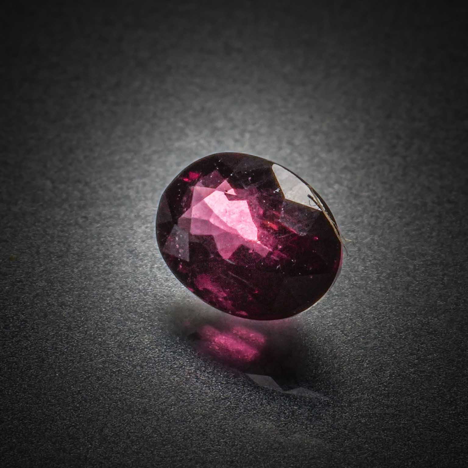 Grenat rose/violet rhodolite ovale sur papier. - Lazuli