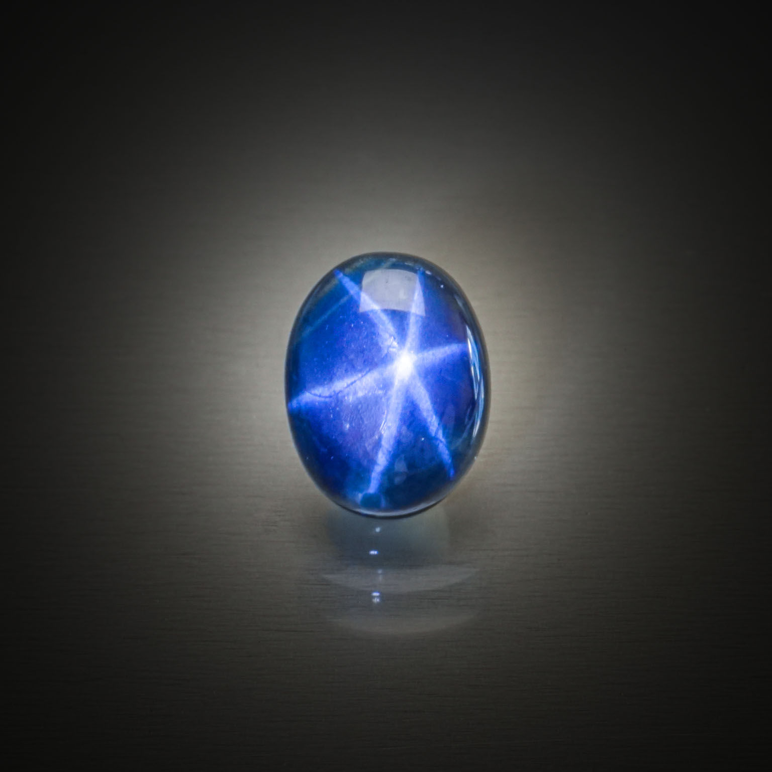 Saphir étoilé ovale cabochon sur papier. - Lazuli