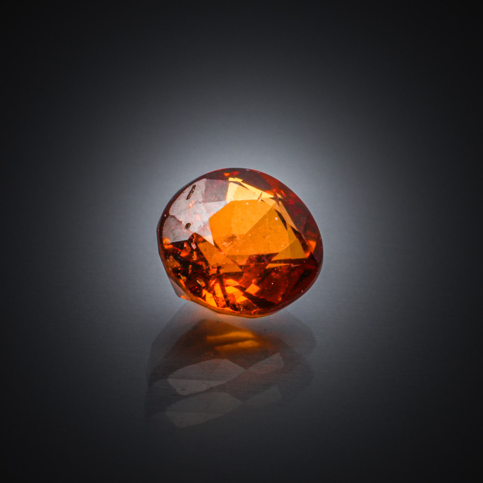 Grenat spessartite ovale sur papier. - Lazuli