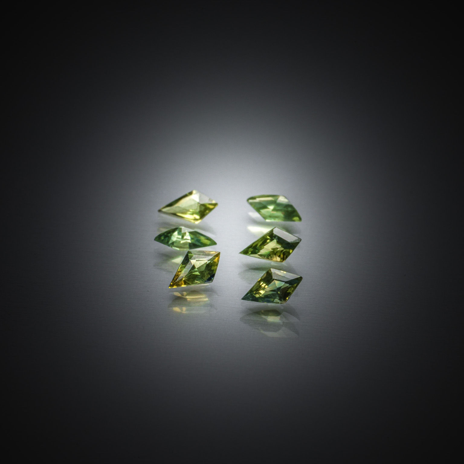 Lot de six saphirs verts kite sur papier. - Lazuli